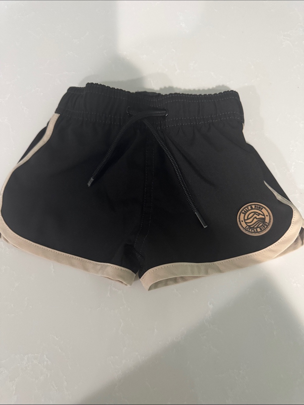 Little Bipsy Black Swim Trunks with Cream Trim